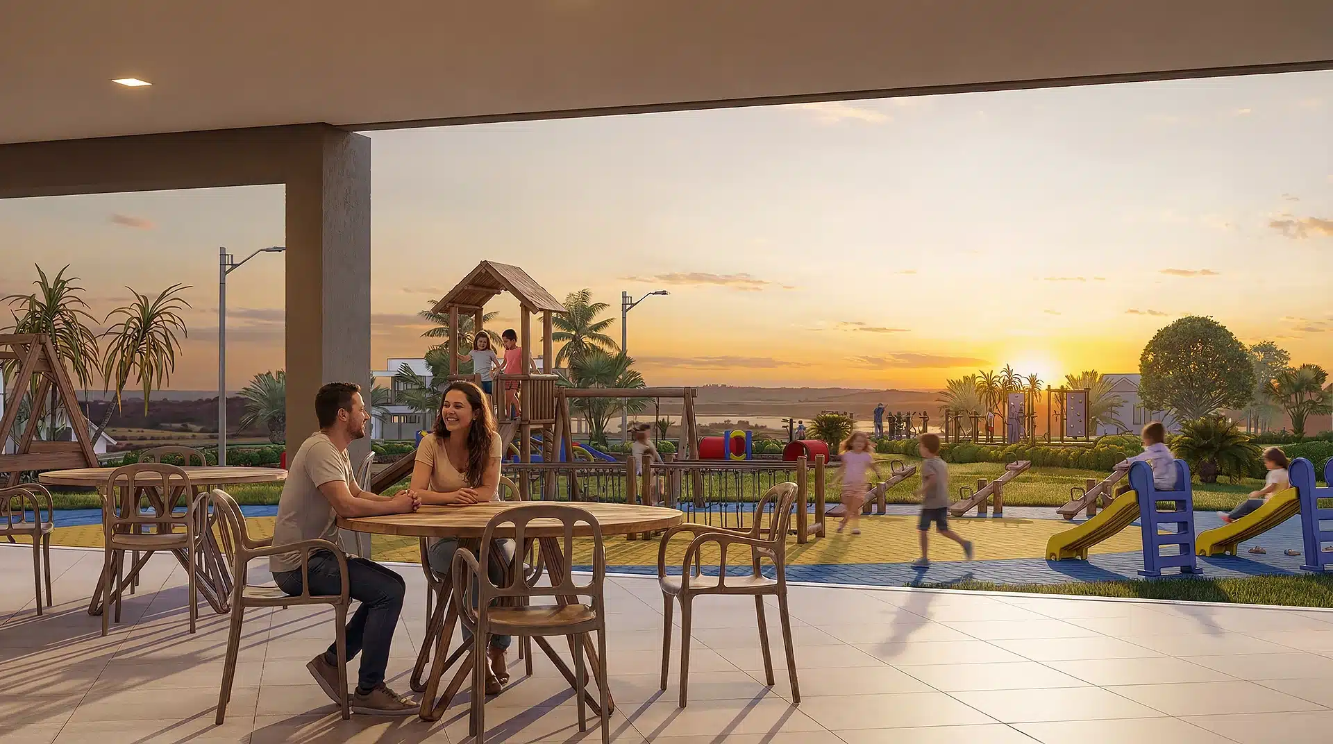 Casal à mesa da área gourmet com o playground ao fundo